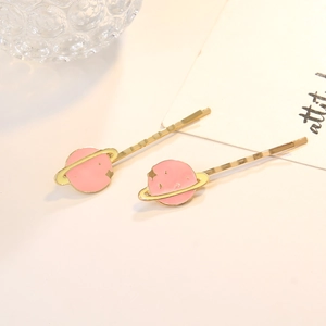 Lot de deux pinces à cheveux planète rose avec motifs étoiles dorées et métal chic