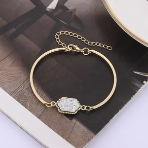 Vintage gold metal bracelet with a sparkling silver hexagonal center piece and adjustable clasp