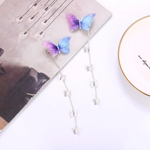 A pair of purple and blue gradient butterfly hair clips with long silver metal tassels