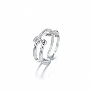 Detail of double-layer silver star and heart ring with sparkling pavé zircon accents