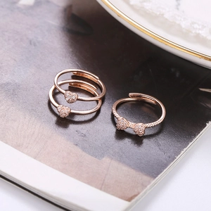 Detailed macro view of rose gold adjustable clover ring set with sparkling zircon stones
