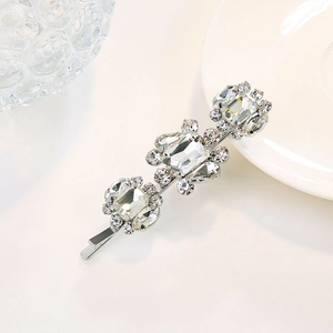 Detailed macro view of silver hair clip with rectangle crystals and sparkling rhinestones