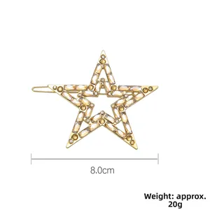 Dettaglio molletta a stella dorata da 8 cm con strass champagne, peso di 20 g