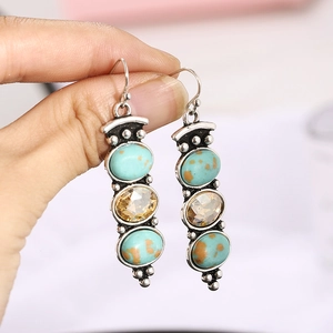 Vintage bohemian style drop earrings with turquoise and amber stones in silver finish