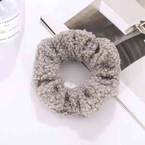 Close-up of light grey sherpa teddy fleece hair scrunchie on a white lifestyle background