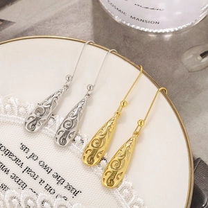 Elegant Celtic hollow teardrop earrings in gold and silver finish with scroll patterns
