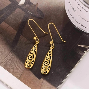 Vintage Celtic style hollow gold drop earrings with intricate floral filigree patterns