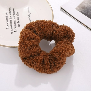 Close-up of a brown teddy fleece scrunchie featuring a soft fluffy texture for winter style