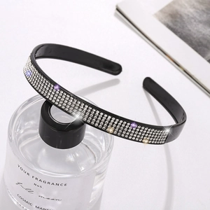 Detailed view of black headband featuring six rows of sparkling rhinestones for hair accessory