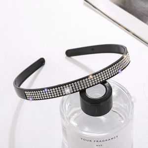 Elegant headband with four rows of sparkling rhinestones on a black resin base hairband