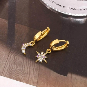 Gold asymmetric huggie earrings with crescent moon and star charms and purple rhinestones
