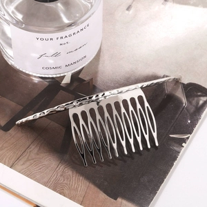 Minimalist silver alloy hair comb with hammered texture and thirteen polished teeth
