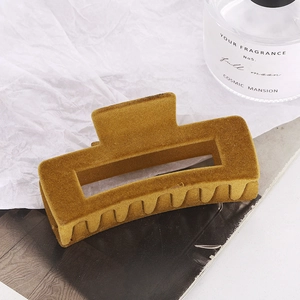 Large ginger yellow flocked rectangular hair claw clip with velvet texture on paper background