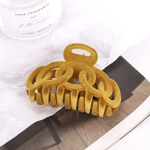 Elegant mustard yellow flocked large hair claw clip with interlocking hollow circles design