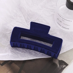 Elegant navy blue velvet geometric hair claw clip for thick hair displayed on white background