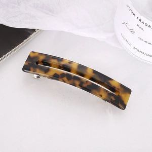 Detail of tortoise shell patterned acetate hair clip with silver metal spring fastener