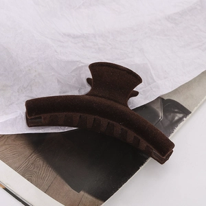 Detailed macro view of large dark brown velvet hair claw clip with strong spring mechanism