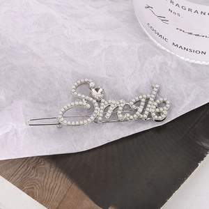 Silver Smile letter hair clip with white pearls and heart crystal on cotton paper