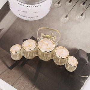 Elegant champagne acrylic hair claw with five gold foil marble circular button accents