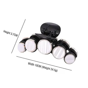 Large black acetate hair claw with shell-like white pearls, 10cm width measurement view