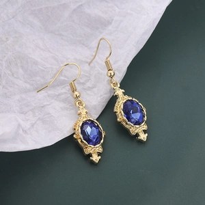 Vintage gold drop earrings with deep blue oval gemstones and intricate filigree details