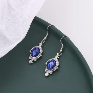 Detailed macro view of vintage royal blue teardrop earrings in antique silver frames