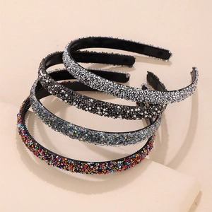 Elegant crystal headband set with rhinestones and pearls on a minimalist display