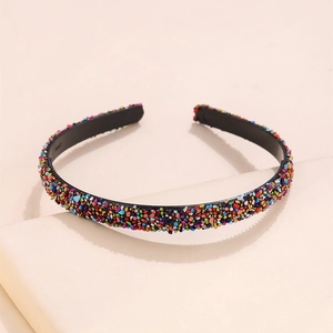 Close-up detail of multi-colored crystal beads on a minimalist black headband