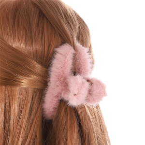 Elegant pink plush hair claw clip for women's winter hairstyling on white background