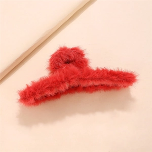 Detail of red plush hair claw clip featuring soft faux fur texture and sturdy large frame