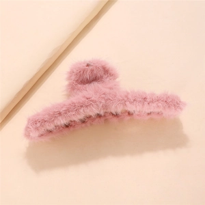 Detailed view of pink plush faux fur hair claw clip with fluffy winter texture