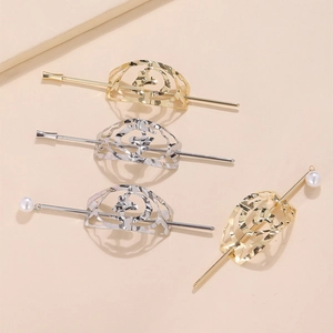 Détail de l'épingle à cheveux géométrique en métal avec perles et design creux