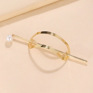 Detail of minimalist gold metal hairpin featuring a smooth curve and elegant white pearl
