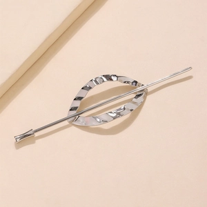 Detailed view of silver minimalist geometric hair pin with wavy metal ring texture