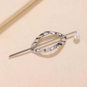 Minimalist metallic geometric hair pin with silver oval wave and pearl on beige background