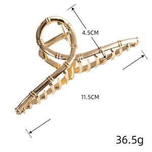 Pinza per capelli dorata in metallo con texture bambù e design a croce, lunga 11,5 cm
