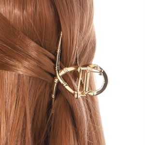 Elegante molletta per capelli in metallo dorato con design a bambù per donna