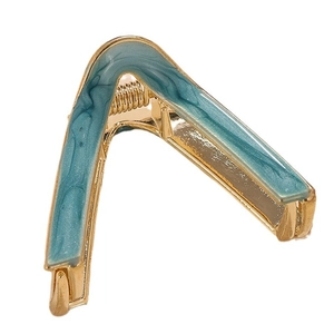 Minimalist V-shaped hair claw clip with blue marble pattern and gold metal finish