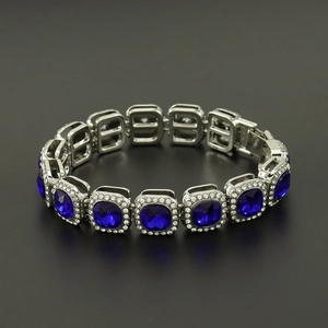 Luxury hip hop bracelet featuring blue square crystals and a silver pavé link design