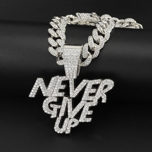Primer plano de cadena cubana plateada con colgante Never Give Up y circonitas AAA
