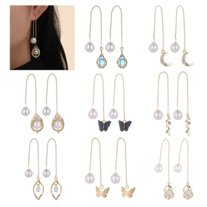 Elegant gold celestial drop earrings with moon stars pearls and butterfly charms