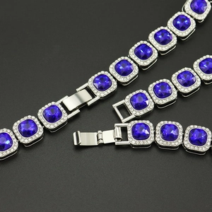 Detail of hip-hop iced out Cuban chain with blue square stone and diamond clasp