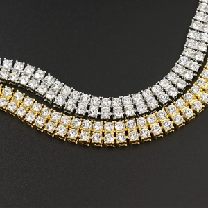 Close-up of gold and silver double-row tennis chains with iced out rhinestones detail