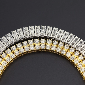 Macro detail of luxury tennis necklace featuring double-row crystal pave in gold and silver