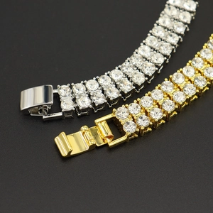 Triple row iced out tennis bracelet in gold and silver plating with shiny crystals
