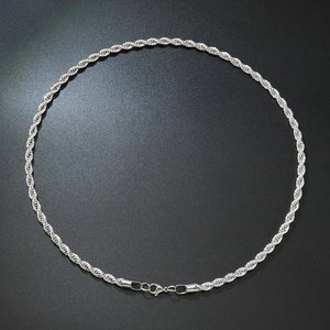 Macro detail of a 5mm silver stainless steel rope chain necklace with lobster clasp