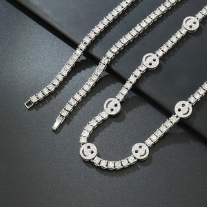 Macro detail of silver tennis chain with micro-paved cubic zirconia smiley face charms