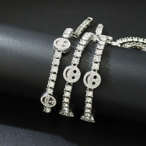 Macro shot of iced out tennis chain with sparkling smile face pendant and silver diamonds