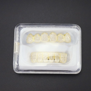 Détail de bijoux dentaires hip hop grillz dorés avec pierres de zircone en boîte