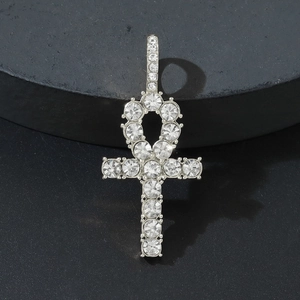 Sparkling silver Ankh cross pendant with full micro-pave crystals on a black stone surface